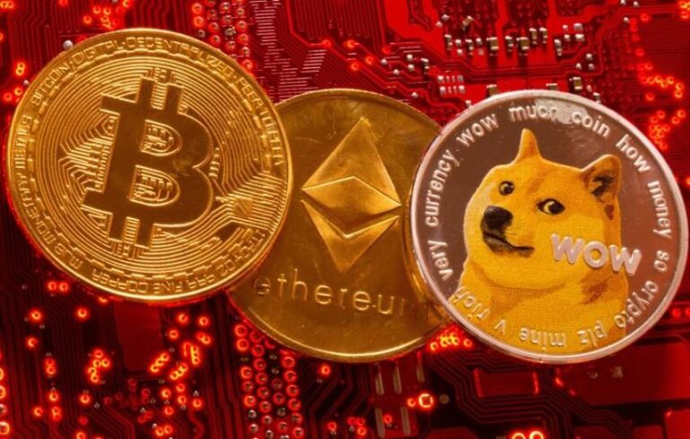 Representations of cryptocurrencies Bitcoin, Ethereum and DogeCoin are placed on PC motherboard in this illustration taken