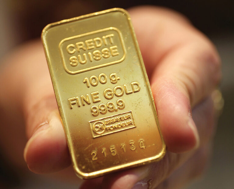 Storekeeper holds gold bar in Singapore