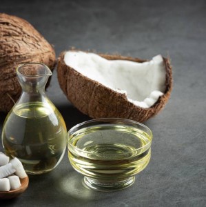 a jug of coconut oil whit coconut put on dark background