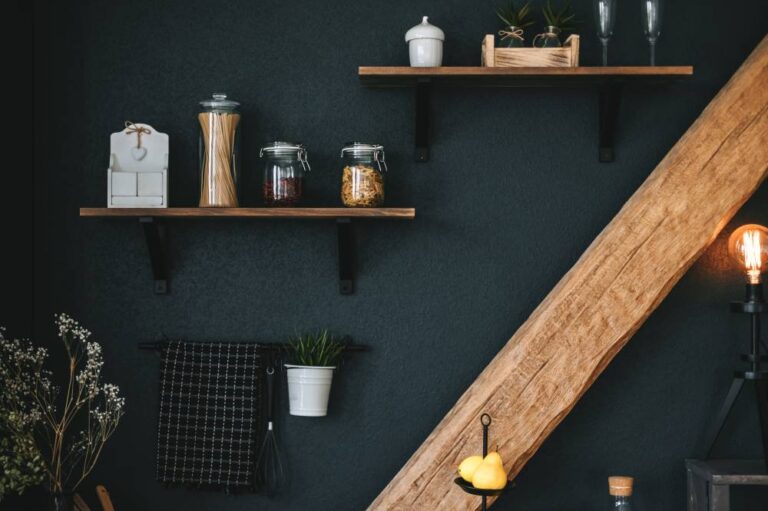 Pasta and grocery in glass jars on a wooden shelf in the kitchen. Detail