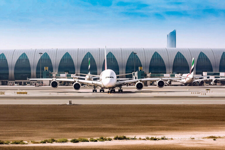 Airport,With,Many,Airplanes,And,Blue,Sky.
