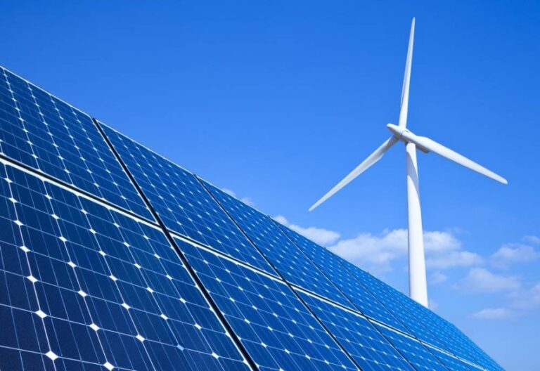 Solar,Panels,And,Wind,Turbine,Against,Blue,Sky