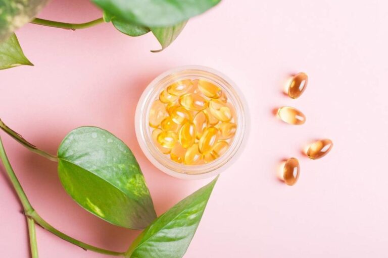 Fish oil capsules (omega-3) on a pink background