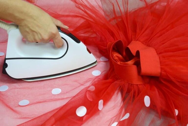 A,Seamstress,With,A,White,Iron,Strokes,A,Red,Tulle