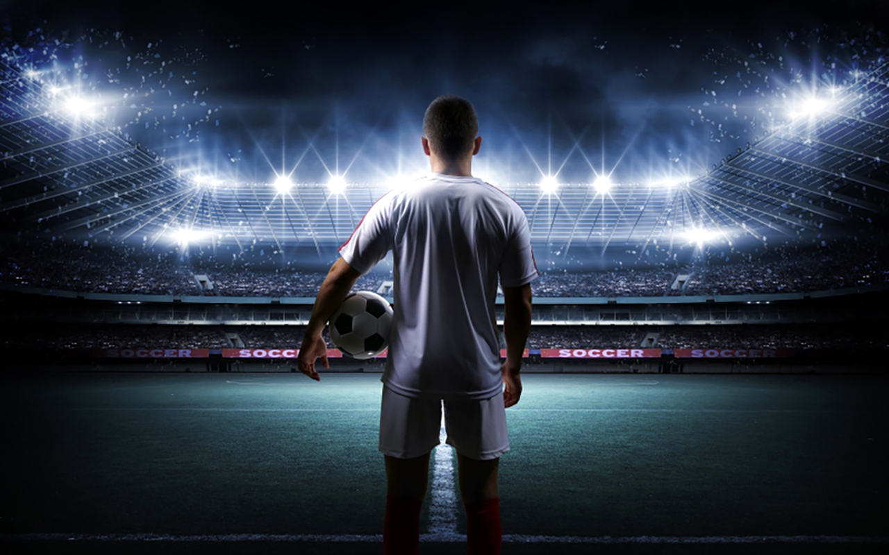 Football,Player,With,Ball,On,Field,Of,Stadium