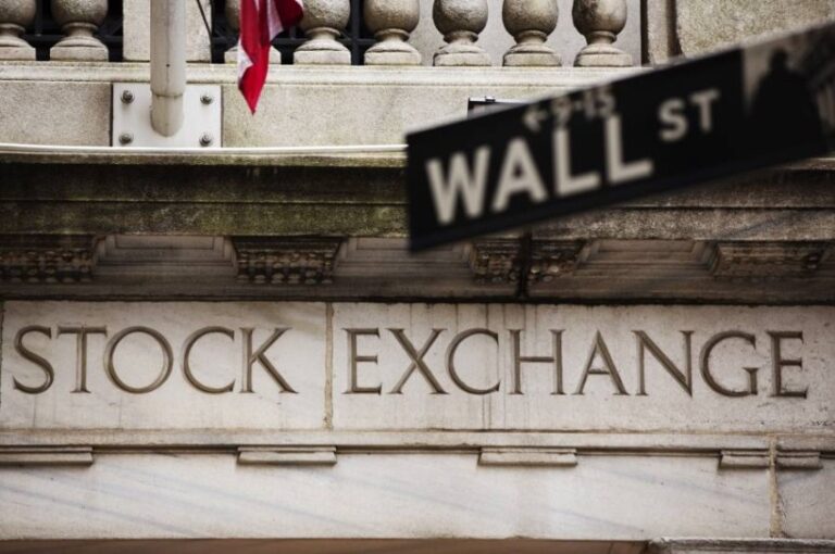 A street sign for Wall Street hangs in front of the New York Stock Exchange