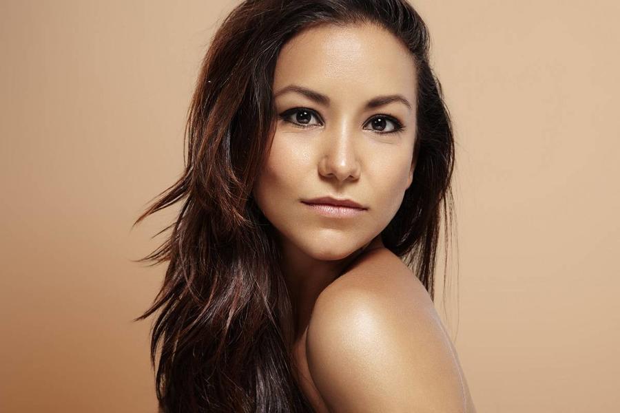 latin woman with ideal skin on a beige background