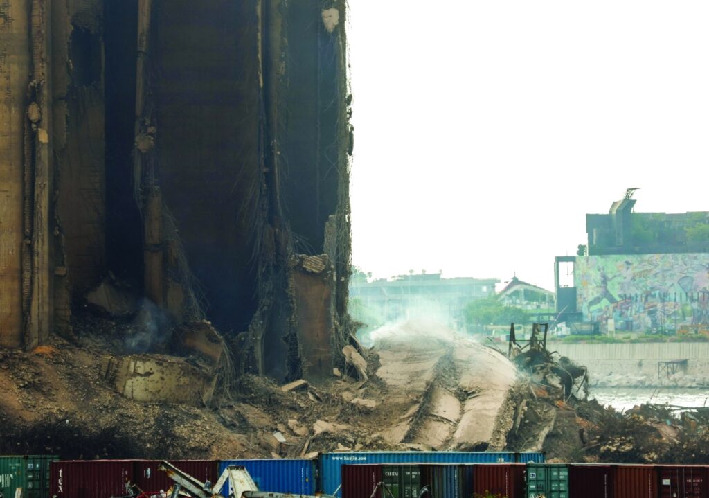 Dust rises as part of Beirut grain silos, damaged in the August 2020 port blast, collapses in Beirut