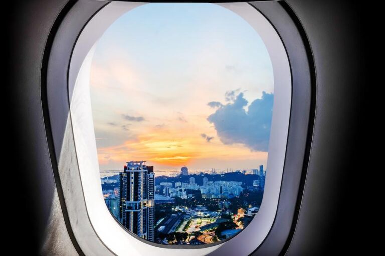 Beautiful sunset city view of singapore from plane window