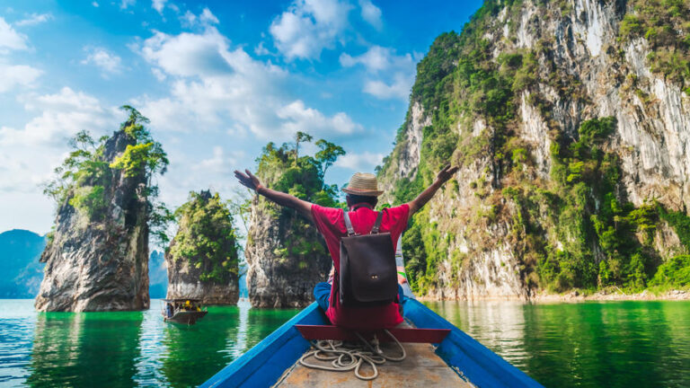 Panorama traveler man on boat joy fun amazed nature rock island