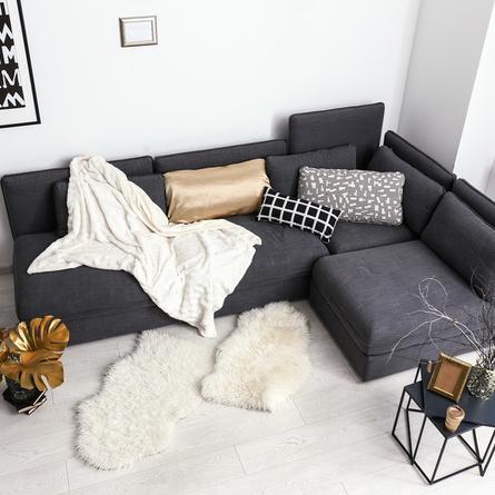 Stylish interior of room with comfortable sofa and golden decor