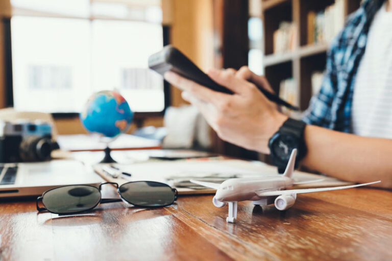Close up airplane model and young men using Calculator calculate