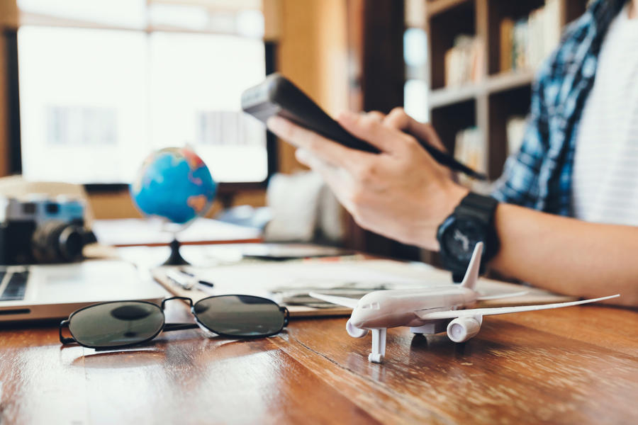 Close up airplane model and young men using Calculator calculate
