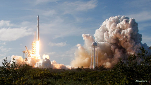 A SpaceX Falcon Heavy rocket lifts off from the Kennedy Space Center in Cape Canaveral