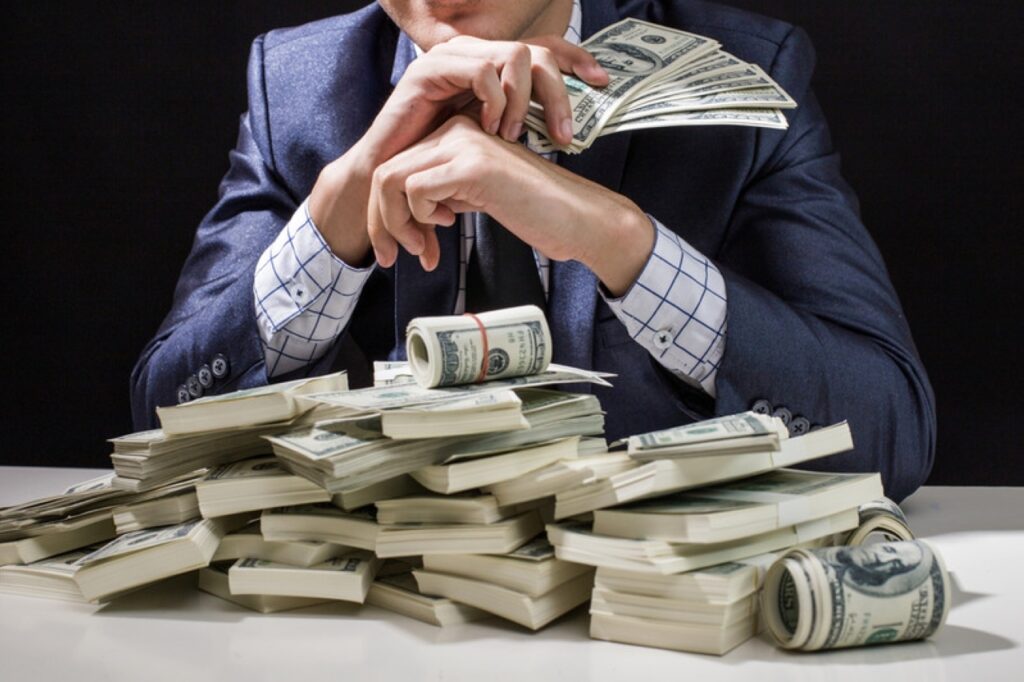 Man,Holding,Money,In,Hand,At,Black,Background,,Man,Receive