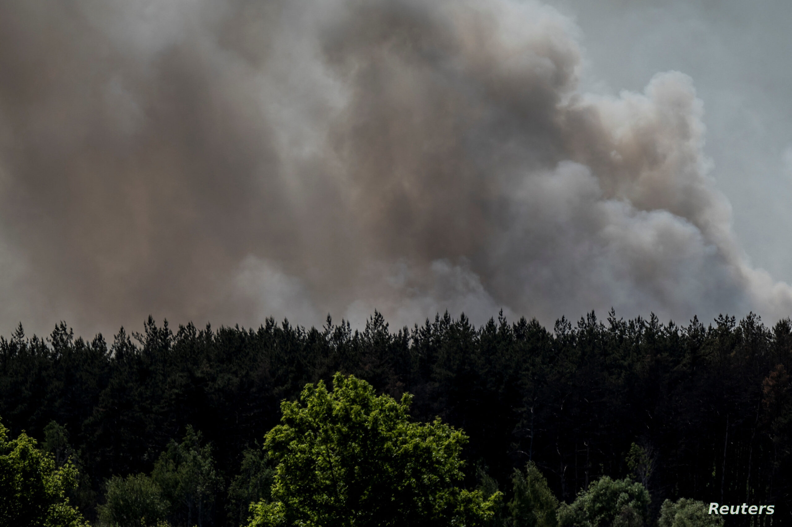 Smoke rises over an area of the Ukraine-Russia border in Kharkiv region