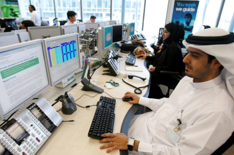 International employees of Standard Chartered work at the new trading room in Dubai International Financial Centre (DIFC) in Dubai