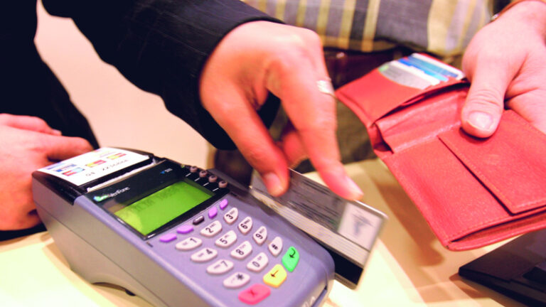 A Woman swipes a credit card of a customer